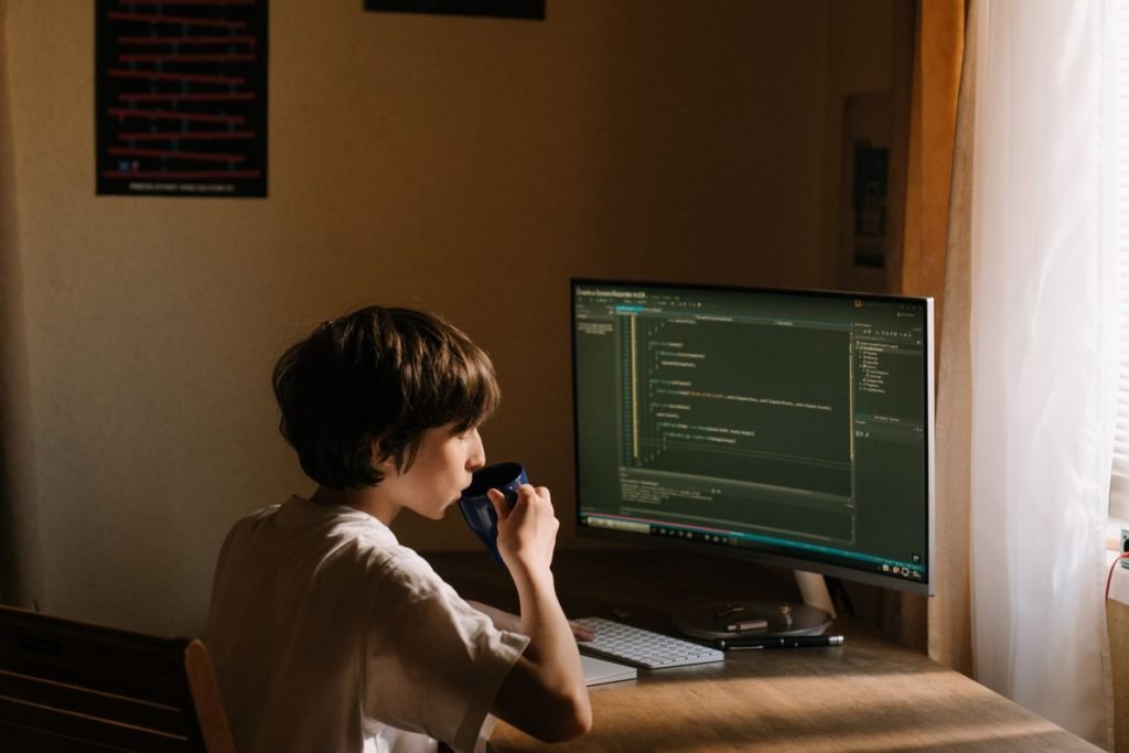 Developer coding at a desk with a cup of coffee