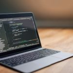 Laptop displaying full stack development code
