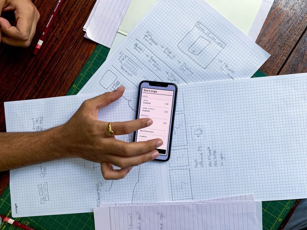 Mobile app design sketches reviewed on a smartphone