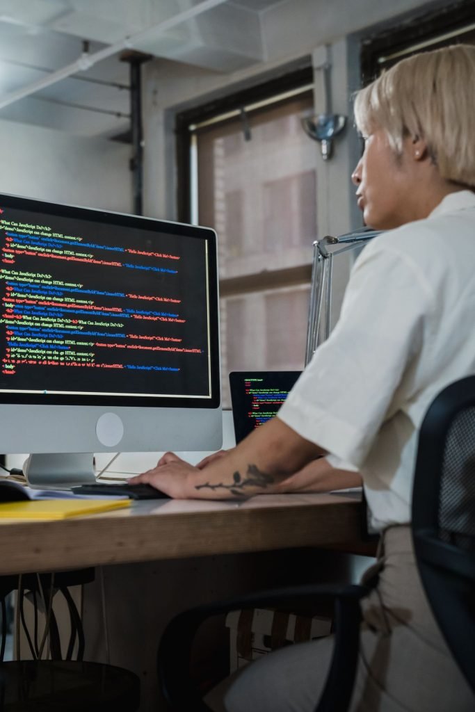 Software engineer working across multiple monitors