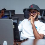 Software engineer focused on laptop work in a modern office