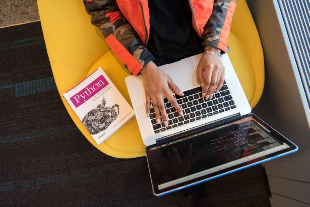 Developer typing code on a laptop while learning