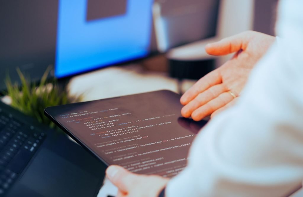 Developer reviewing code on a tablet in the office